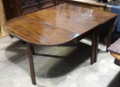 A 19th century mahogany drop flap dining table