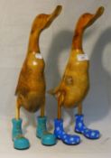 A pair of wooden ducks in wellies