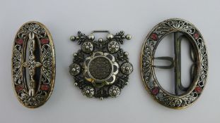 A Maltese silver belt buckle with an 18th century coin in centre and two similar silvered buckles