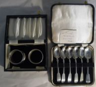 A cased set of six Victorian silver teaspoons and a pair of napkin rings