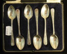 A cased set of engraved silver spoons