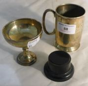 A small silver Christening mug and a small silver trophy