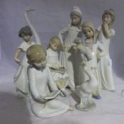 A collection of Nao figures and Lladro