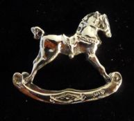 A miniature silver rocking horse