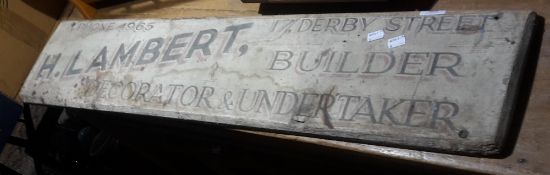 A vintage painted wooden trade sign