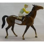A Beswick brown racehorse with jockey up
