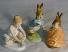 A Doulton ballerina and two Peter Rabbit figurines