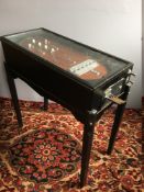A vintage Tilter pinball table With ebonised case, the board of typical form,