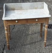 A Victorian pine marble top wash stand
