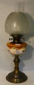A Victorian oil lamp with an etched clear glass shade