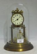 A brass anniversary clock under a glass dome