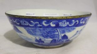 An Oriental blue and white dish with metal rim,