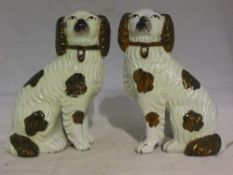 A pair of small 19th century Staffordshire models of spaniels with lustre decoration