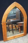 An arched topped pine framed mirror