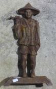 A cast iron doorstop modelled as an Eastern figure