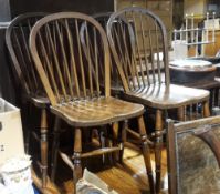A set of four early 20th century elm seated stick back dining chairs