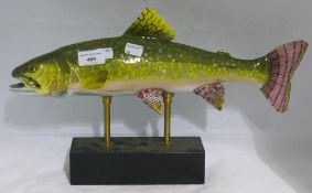 A porcelain model of a trout on a stand