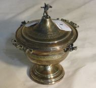 A Continental silver caviar dish topped with a cherub