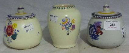 Three Poole pottery jars and covers