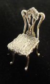 A silver miniature chair