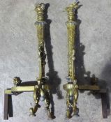 A pair of late 19th century ormolu and brass fire dogs of torchere design
