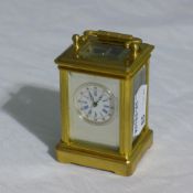 A miniature silver face carriage clock