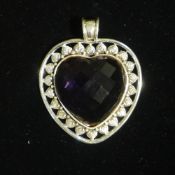 A silver and amethyst heart shape pendant