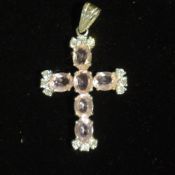 A silver and pink stone crucifix