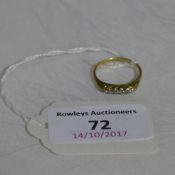 An unmarked gold and diamond set ring (2 grammes all in)