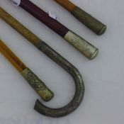 Three regimental swagger sticks and another