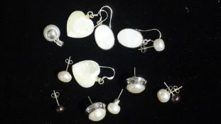 Six pairs of silver and pearl earrings