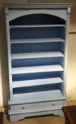 A blue painted bookcase