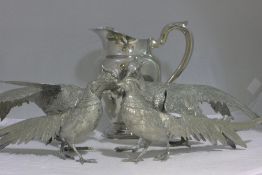 Four plated model pheasants and a plated lemonade jug