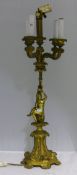 A bronze lamp mounted with a putto