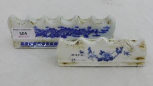 Two blue and white brush rests