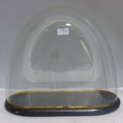 A Victorian glass dome on an ebonised base