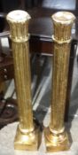 A pair of gilt wooden lamp stands