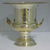 A silver plated three tier cake stand and a wine cooler