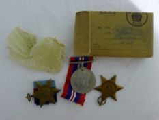 A boxed set of three WWII service medals