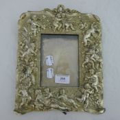 A silvered cherub figural photograph frame