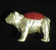 A silver pin cushion in the form of a bulldog