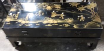 A chinoiserie trunk form coffee table