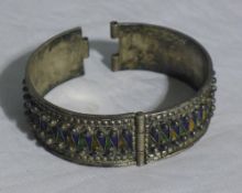 An Eastern silver and enamel bangle