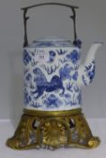 A blue and white kettle on stand