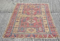 A large Caucasian rug and another smaller