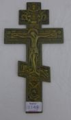 A Russian orthodox gilt metal crucifix with cast decoration and script,