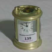 A round silver plated miniature carriage clock