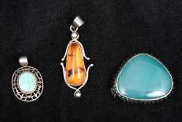 Two white metal pendants, one set with turquoise and stamped 925,