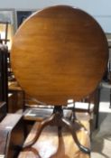 A George III mahogany bird cage tilt top tripod table