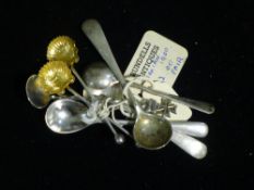 A small collection of silver mustard spoons